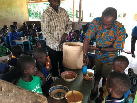 Volunteers serving a meal to schoolchildren