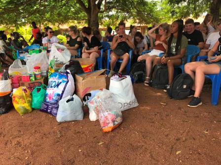 Volunteers seated with bagged donations ready for distribution